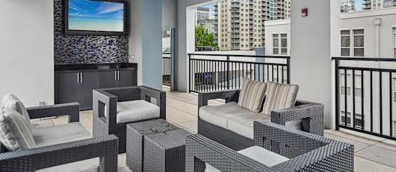 A balcony with a black railing and a white couch.