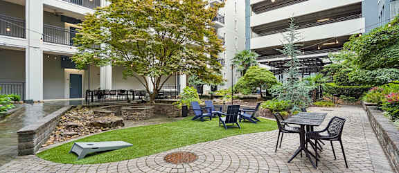 A courtyard with a table and chairs surrounded by buildings.