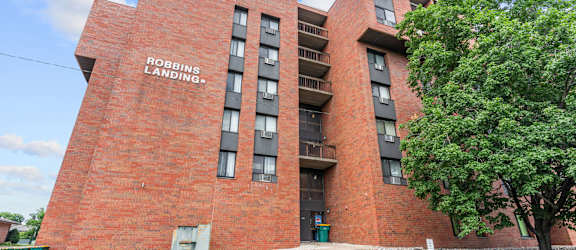 A red brick building with the words "Robins Landing" on the side.