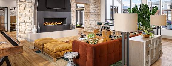 A modern living room with a brick fireplace and a pool table.