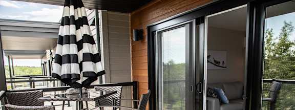 a patio with a table and chairs and sliding glass doors