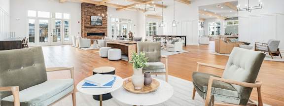A living room with a grey couch, a white coffee table, and a wooden floor.