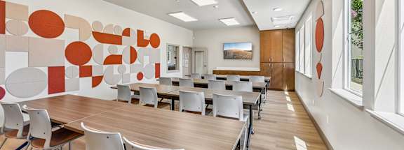A conference room with a long table and chairs.
