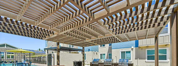 A sunny day at the outdoor seating area with tables and benches.