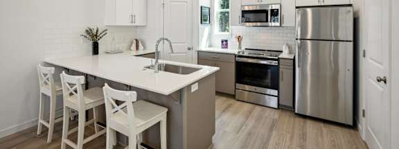 Tile backsplash, quartz counters, and abundant storage. at Holmes Park Townhomes, Oregon City, OR, 97045