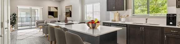 A modern kitchen with a large island and bar stools.