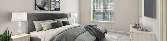 A bedroom with a large bed and a window.