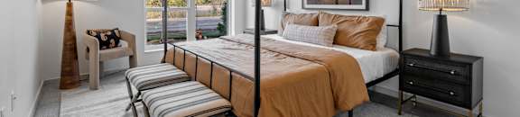a bedroom with a bed and a large window