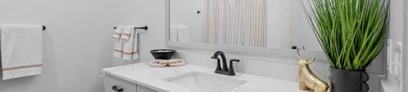 a white bathroom with a large mirror and a toilet