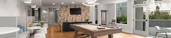 A modern living room with a wooden floor and furniture.