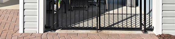 A black grill is on a patio with a black gate. at GRANDVIEW AT CLEAR POND Apartments , MYRTLE BEACH, SC, 29579