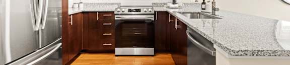 a kitchen with stainless steel appliances and granite counter tops