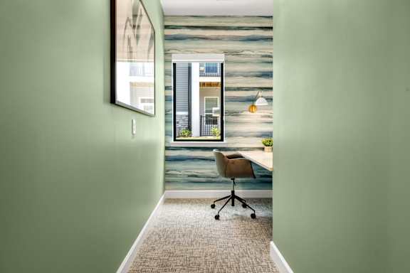 A room with a green wall and a grey carpet.