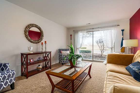 a living room with a couch and a coffee table and a sliding glass door