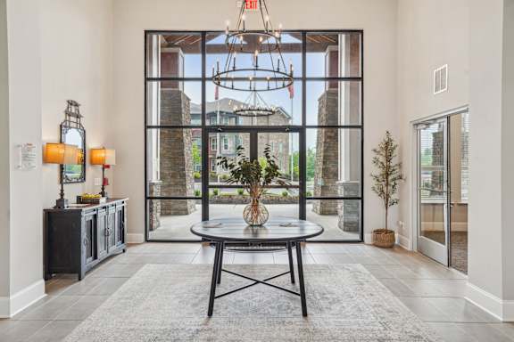 A modern interior with a glass door leading to a balcony.