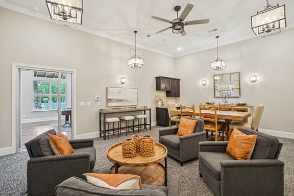 A living room with grey couches and a wooden coffee table.