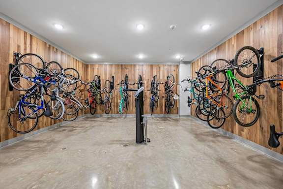 A room full of bicycles hanging on the wall.