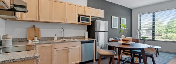 a kitchen and dining area in a 555 waverly unit