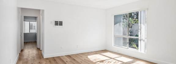 A living room with a white couch and a coffee table.