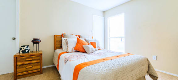 Forest Lake at Oyster Point in Newport News, VA interior view of bedroom two with orange and white linens