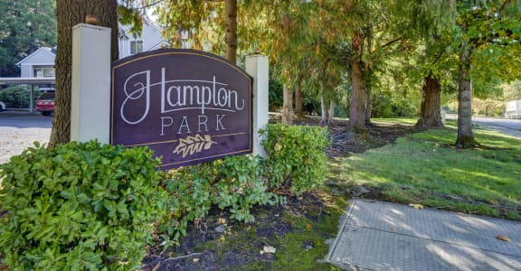 a sign for hamden park in front of trees