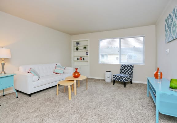 a living room with a couch and a table and a window  at Woodhaven, Everett, WA