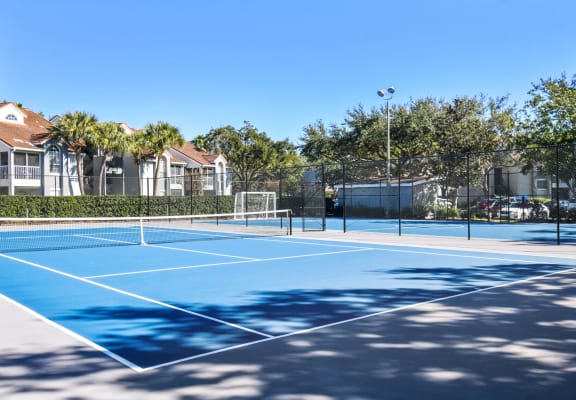tennis courts at the enclave at woodbridge apartments in sugar land, tx