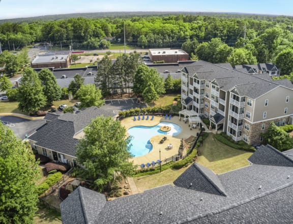 an aerial view of the resort style pool and hot tub at the reserve at south coast apartments