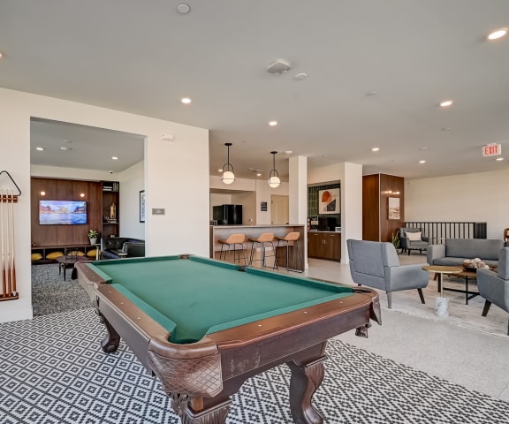 a resident clubhouse with a pool table and bar