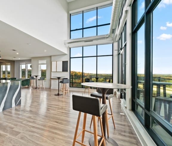 a large room with a kitchen and a bar and large windows  at Vue at Westchester Commons, Midlothian, 23113