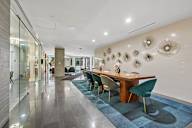 A conference room with a long table and chairs.