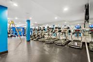 A gym with treadmills and exercise equipment.