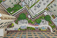 A view of a courtyard from above with a fountain in the middle.