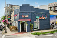 A blue building with a red awning and a sign that says "Jack's".