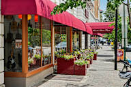 A street view of a church brand place with a red awning.