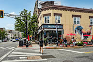 A street scene with a pedestrian crossing the road.