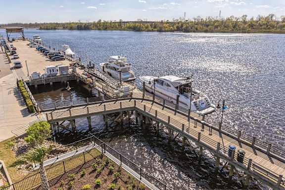 several boats docked at a dock on a body of water at Metropolitan at the Riverwalk, North Carolina