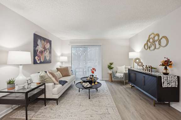 a living room with a couch and a table at St. Andrews Reserve Apartments in Wilmington, NC