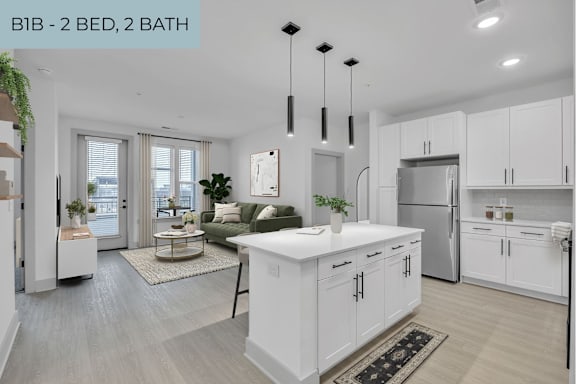 A modern kitchen with white cabinets and a central island.