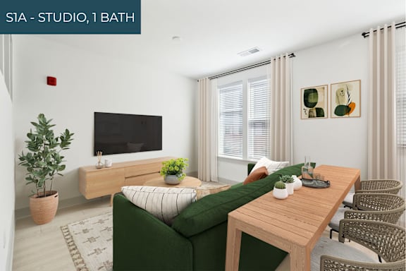 A living room with a green couch, wooden table, and a television.