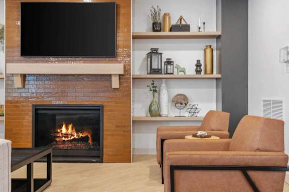 A living room with a fireplace and a television above it.