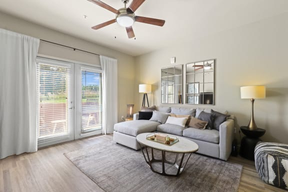 a living room with a couch and a table  at The Ridge at Thornton Station in Thornton, Colorado 80229