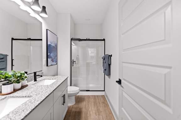 A white bathroom with a walk-in shower and a toilet.
