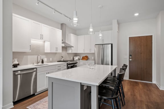a kitchen with white cabinetry and stainless steel appliances