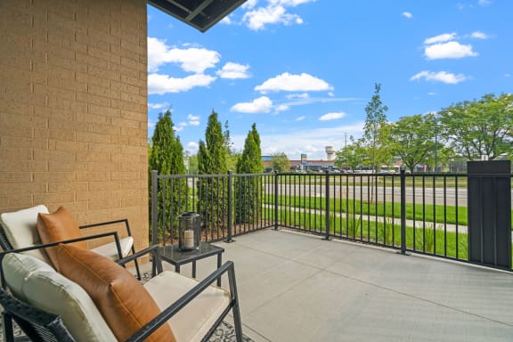 a balcony with a patio furniture and a coffee table