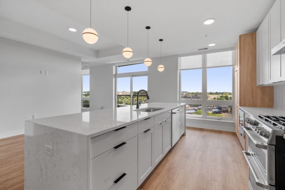Expansive Kitchen Island with Overhead Lighting
