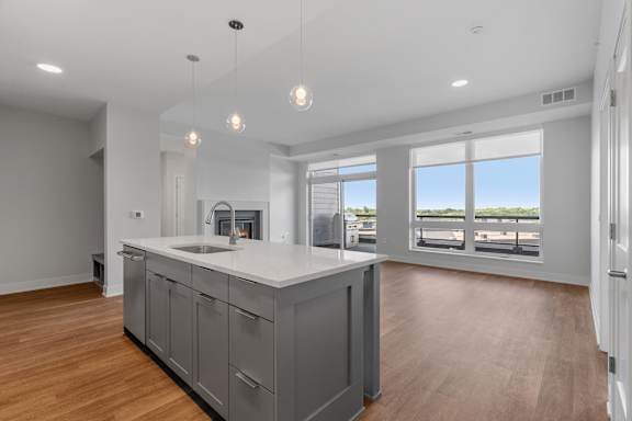 Expansive Kitchen Island with Overhead Lighting