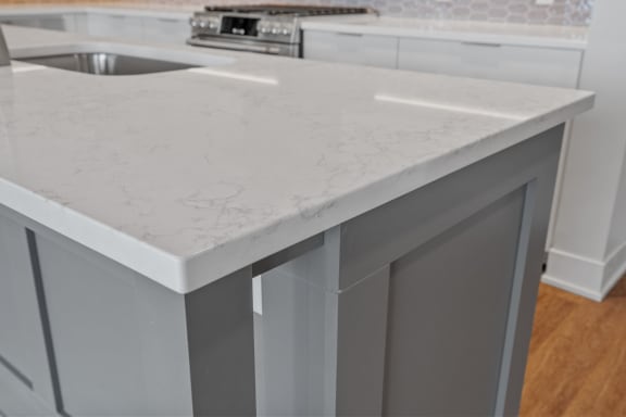 Expansive Kitchen Island with Overhead Lighting