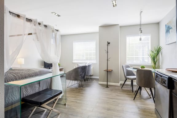 a bedroom with a bed and a sink and a dining room