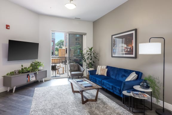 a living room with a blue couch and a tv